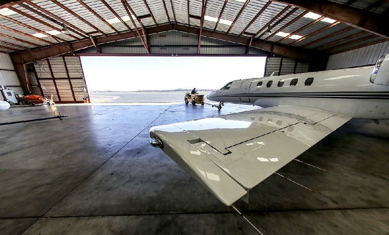 FILE — A business jet is towed from a hangar at North Little Rock Municipal Airport in this 2018 file photo. 