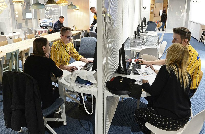 Interior design advisers help customers at a new downtown Ikea store in Warsaw, Poland. 