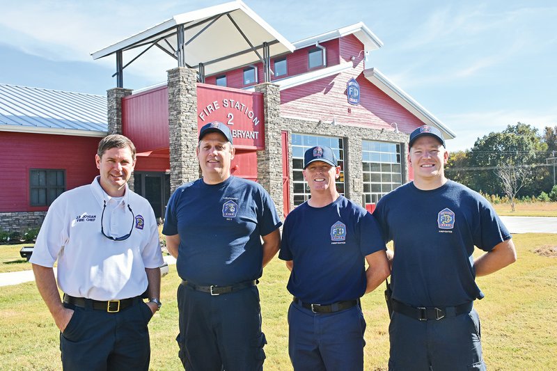 Bryant Fire Chief J.P. Morgan, from left, Lt. Kevin Smith, Clay Heslep and Zac Robinson stand in front of Farm Hill Fire Station No. 2, which is painted red to resemble a barn. Bryant’s two new fire stations —Station No. 2, shown here on South Reynolds Road, and Station No. 3, on Northlake Road — are identical in design, except for the outside.