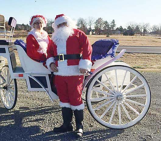 Santa and Mrs. Claus, aka Floyd Spears and Eva Tapp, pose last year with a carriage at the Museum of Veterans and Military History in Vilonia, 
53 N. Mount Olive. A Christmas Bazaar is scheduled from 10 a.m. to 
4 p.m. Saturday with free carriage rides from 10 a.m. to 1 p.m. Homemade soup, gumbo and chicken and dumplings will be available for $5 per bowl, and jewelry and baked goods will also be sold.