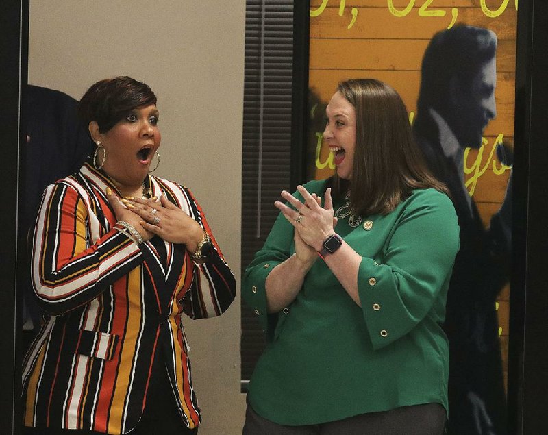 Tasha Wilson (left), a second-grade teacher at Kingsland Elementary School in Cleveland County, gets the news of her selection as a Milken Educator Award winner as teacher Kristina Varnell applauds during a ceremony Friday morning at the school. More photos are available at arkansasonline.com/galleries. 