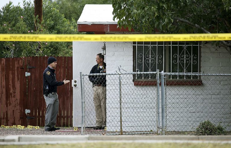 Police investigate Friday at the home in Tucson, Ariz., where a deputy U.S. marshal was shot and killed Thursday.