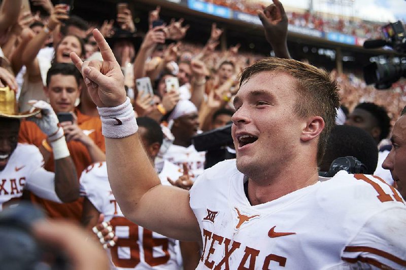 Texas quarterback Sam Ehlinger celebrates after leading the Longhorns to a 48-45 victory over Oklahoma on Oct. 6 in Dallas. Ehlinger threw for 314 yards and 2 touchdowns as Texas beat Oklahoma for the first time since 2015.