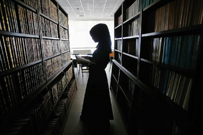 Student Enisa Bekteshi stands inside the library of the Faculty of Islamic Studies in the Kosovo capital, Pristina. The Islamic Community of Kosovo secretary general, Resul Rexhepi, says women are now acting as spiritual teachers in some 800 mosques throughout the country. 