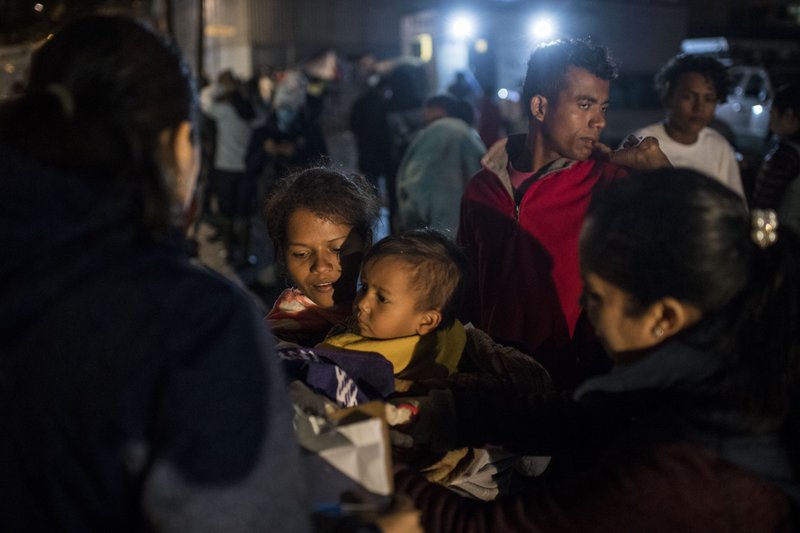 Members of the migrant caravan get onto buses to be transported from Unidad Deportiva Benito Juarez, where thousands of migrants were staying in tents outside, to a new shelter in a vacant event space called El Barretal in Tijuana, Mexico, on Nov. 30, 2018. MUST CREDIT: Washington Post photo by Carolyn Van Houten