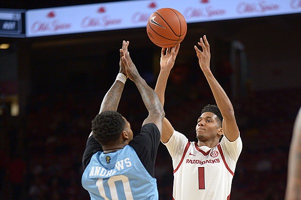 Arkansas guard Isaiah Joe (1) takes a 3-point shot over Florida International forward Devon Andrews (10) Saturday, Dec. 1, 2018, during the second half of play in Bud Walton Arena. Visit nwadg.com/photos to see more photographs from the game.