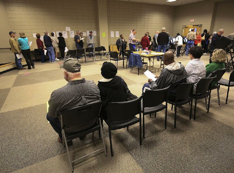 In this Oct. 23 photo, people wait in line during early voting at the Main Branch of the William F. Laman Public Library in North Little Rock.