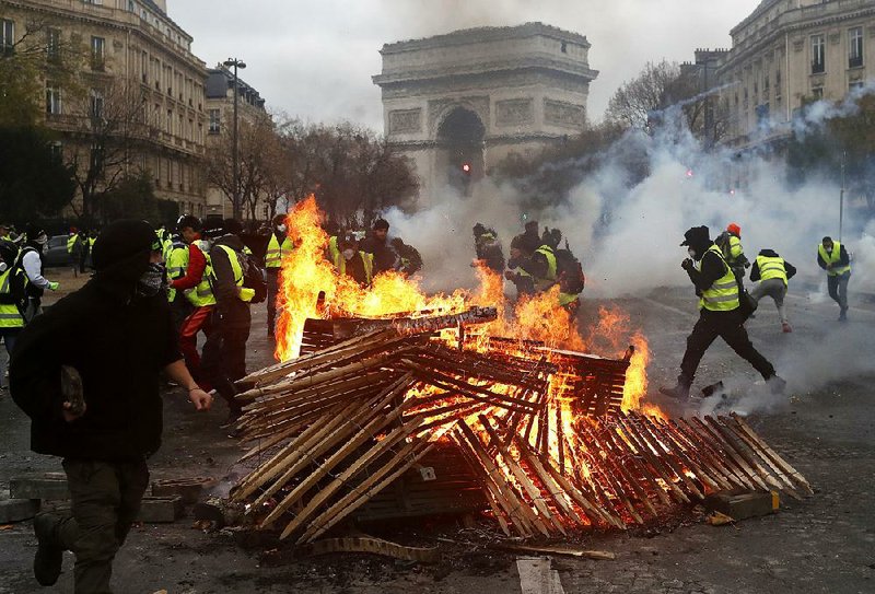 Paris protest turns into riot of burning, looting; famed Arc defaced