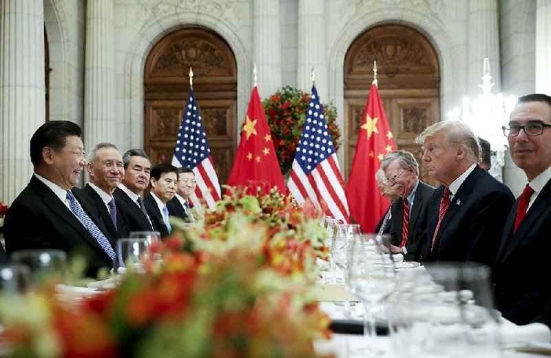 Chinese President Xi Jinping (left) and President Donald Trump hold a dinner meeting Saturday evening in Buenos Aires, Argentina. 