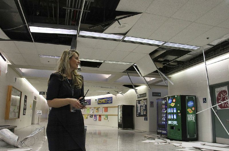 Allison Susel, the acting principal at Chugiak High School in Chugiak, Alaska, examines the damage caused by Friday’s 7.0-magnitude earthquake. story.lead_photo.caption