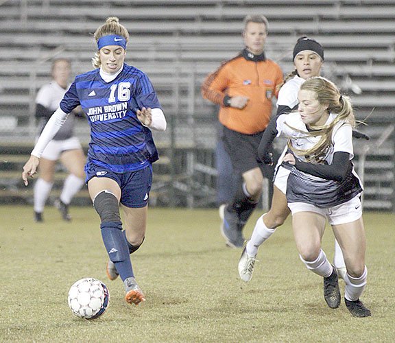 Tom Harris/Special to Siloam Sunday John Brown junior Kristen Howell, left, chases down a loose ball as Southeastern (Fla.) defender Sierra Clayton defends during Tuesday's NAIA Round of 16 game held in Orange Beach, Ala. Southeastern defeated John Brown 3-0 to end the Golden Eagles' season.
