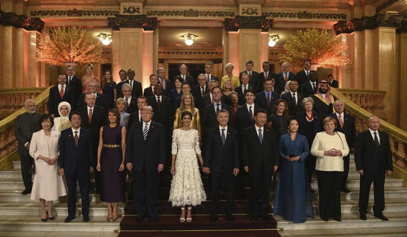 In this photo released by the press office of the G20 Summit, leaders and their partners pose for a group photo prior to a gala dinner at the Colon Theater in Buenos Aires, Argentina, Friday. Leaders from the Group of 20 industrialized nations are meeting in Buenos Aires for two days starting today. (G20 Press Office via AP)

