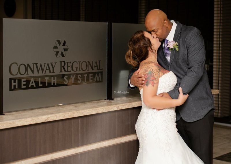 Marie White and Kenny Brown share a kiss following their swift, surprise wedding at Conway Regional Medical Center.
