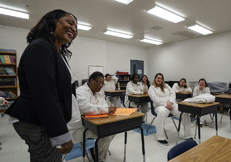 Angela Crutchfield, a coordinator and instructor for the Second Chance Pell Experimental Sites Initiative program, jokes with her students in class at the Department of Correction’s Wrightsville Unit on Wednesday.