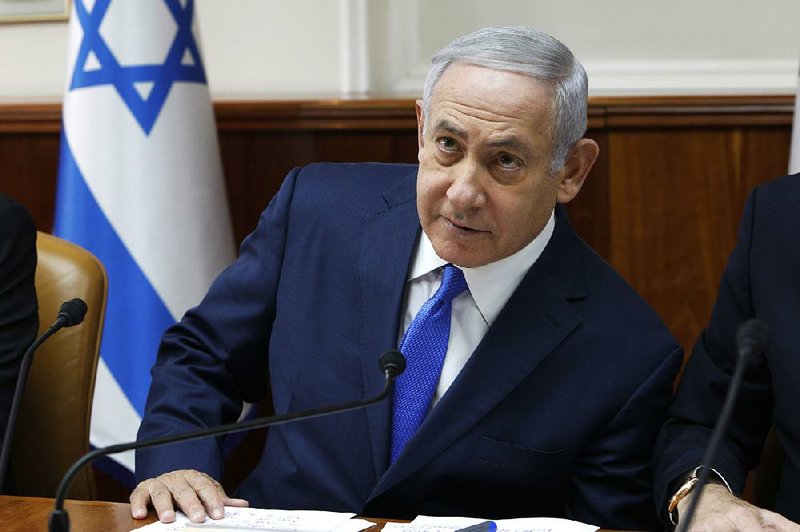 Israeli Prime Minister Benjamin Netanyahu attends the weekly cabinet meeting at his office Sunday in Jerusalem. Israeli police on Sunday recommended indicting Netanyahu on bribery charges. 