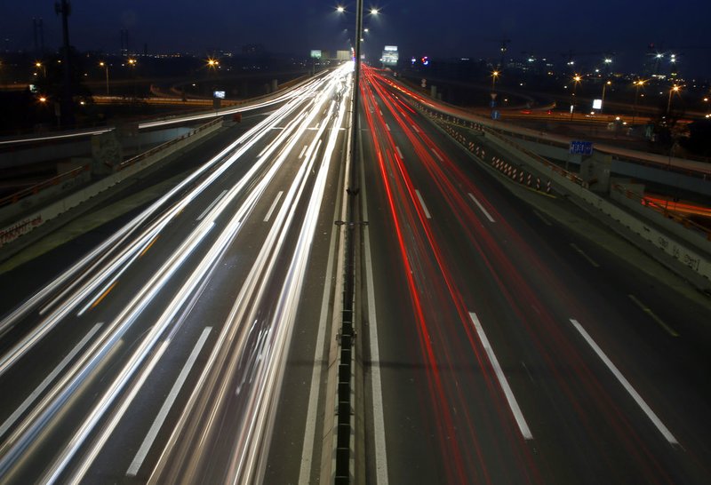 In this image taken with a slow shutter speed, vehicles move on a road in Belgrade, Serbia, Monday, Dec. 3, 2018. The COP24 UN Climate Change Conference is taking place in Katowice, Poland. Negotiators from around the world are meeting for talks on curbing climate change. (AP Photo/Darko Vojinovic)