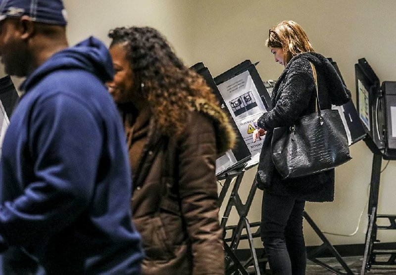 Morgan Warden casts her ballot in the Little Rock mayoral race on the last day of early voting Monday. The runoff election takes place today between Frank Scott and Baker Kurrus.