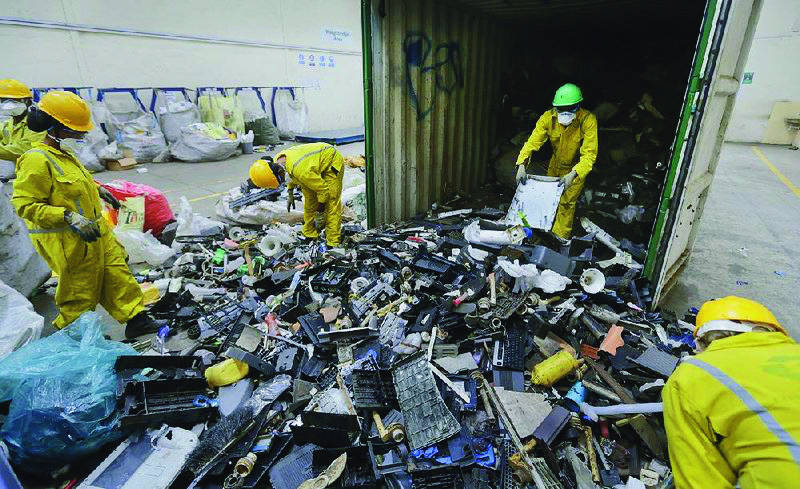 An Associated Press file photo shows workers offload recycle collection.