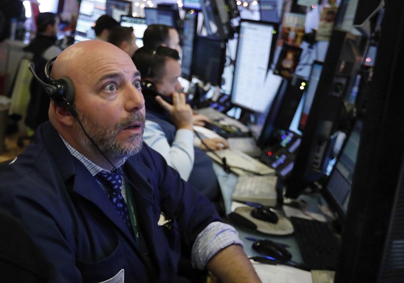 Trader Vincent Napolitano works on the floor of the New York Stock Exchange, Monday, Dec. 3, 2018. Stocks are opening sharply higher on Wall Street, following gains in overseas markets after the U.S. and China struck a 90-day truce in their trade dispute. (AP Photo/Richard Drew)