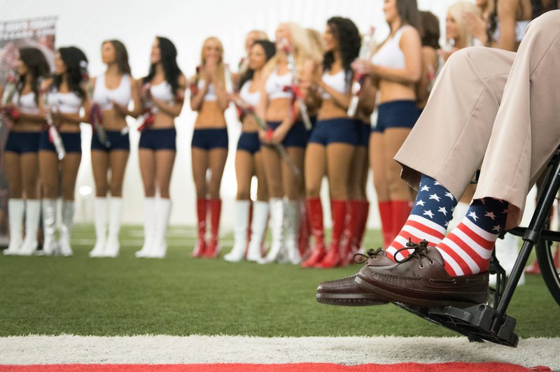 The Associated Press BRIGHT SOCKS: Former President George H.W. Bush wears American flag socks as he presents roses to the new Houston Texans cheerleaders during a ceremony introducing the new squad at the team's NFL football training facility in Houston on April 17, 2013. Bush often sported bright socks, sometimes with loud, unusual patterns. He died Friday, in Houston at age 94.