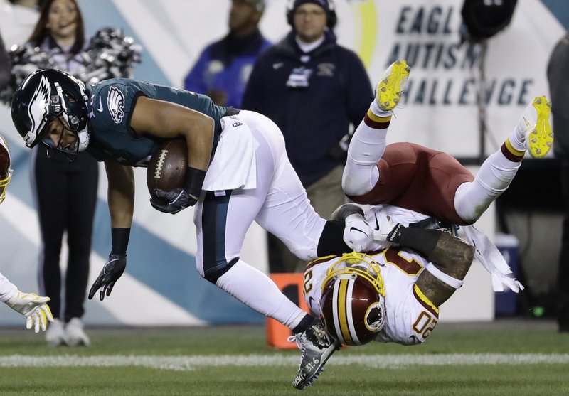Philadelphia Eagles' Golden Tate (19) is tackled by Washington Redskins' Ha Ha Clinton-Dix (20) during the second half of an NFL football game, Monday, Dec. 3, 2018, in Philadelphia. (AP Photo/Michael Perez)