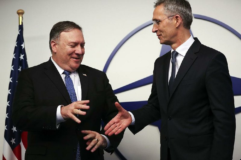 Secretary of State Mike Pompeo (left) is greeted by NATO Secretary-General Jens Stoltenberg before a meeting Tuesday at NATO headquarters in Brussels. 