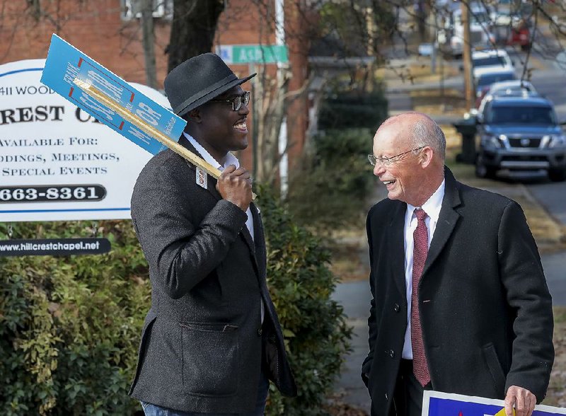 Mayoral candidates Frank Scott, Jr., left, and Baker Kurrus, share a laugh outside a polling place in Little Rock's Hillcrest neighborhood Tuesday morning. 