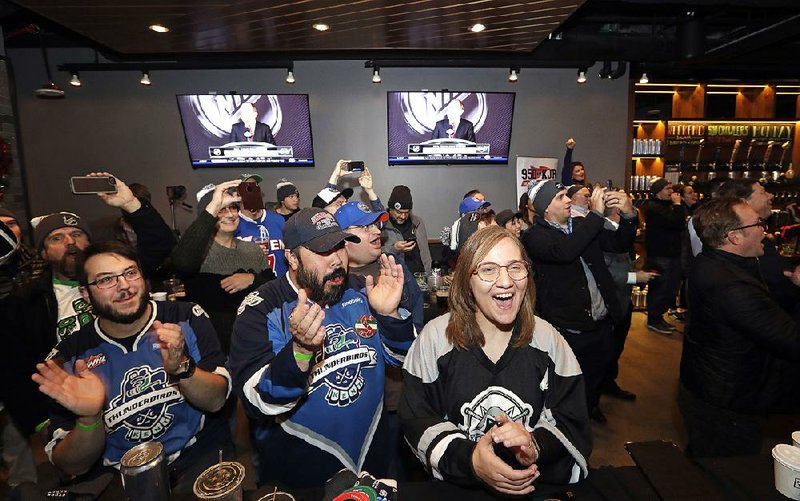Hockey fans cheer  the announcement of a new NHL hockey team in Seattle at a party Tuesday. The NHL Board of Governors unanimously approved adding Seattle as an expansion team for the 2021-2022 season. 