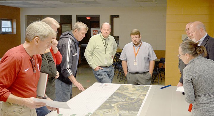 Keith Bryant/The Weekly Vista Bella Vista city council member Doug Fowler (left), alongside other Bella Vista residents and ARDOT staff, examines a map provided by the Arkansas Department of Transportation.