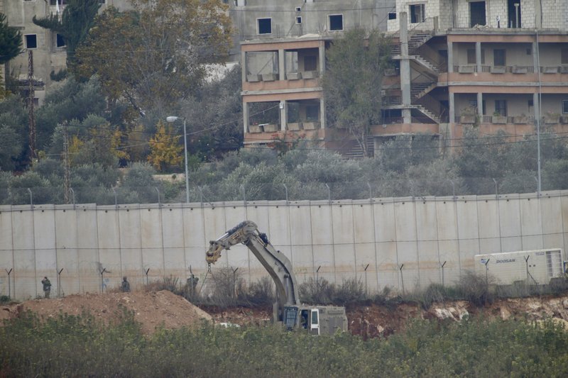 Israeli military digger works on the border with Lebanon in the northern Israeli town of Metula, Tuesday, Dec. 4, 2018. The Israeli military launched an operation on Tuesday to &quot;expose and thwart&quot; tunnels built by the Hezbollah militant group it says stretch from Lebanon into northern Israel. (AP Photo/Ariel Schalit)