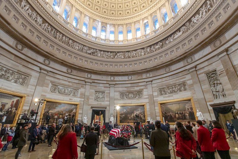 The last visitors pay respects to the late president, George H.W. Bush, as the public viewing comes to an end at the U.S. Capitol Rotunda, Wednesday, Dec. 5, 2018. (AP Photo/J. Scott Applewhite)