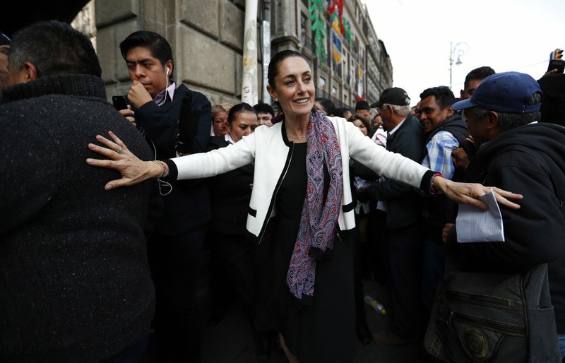 Mexico City's newly sworn in mayor, Claudia Sheinbaum, takes a walk to the Zocalo in Mexico City, Wednesday, Dec. 5, 2018. Sheinbaum is Mexico City's first elected female mayor. (AP Photo/Eduardo Verdugo)