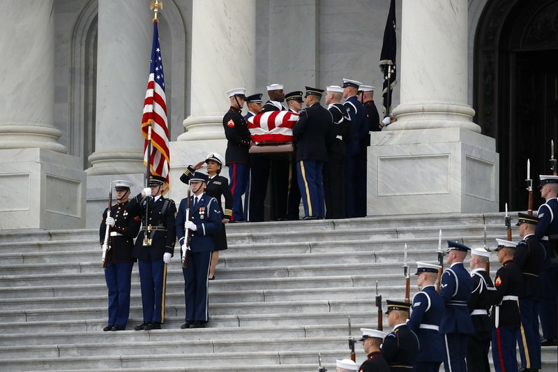 The flag-draped casket of former President George H.W. Bush is carried by a joint services military honor guard from the U.S. Capitol, Wednesday, Dec. 5, 2018, in Washington. (AP Photo/Alex Brandon, Pool)