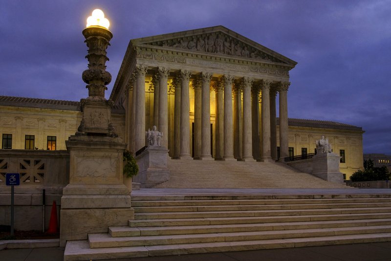 FILE - In this Oct. 5, 2018, file photo, the U. S. Supreme Court building stands quietly before dawn in Washington. The Constitution says you can’t be tried twice for the same offense. And yet Terance Gamble is sitting in prison today because he was prosecuted separately by Alabama and the federal government for having a gun after an earlier robbery conviction. he Supreme Court is considering Gamble’s case Thursday, Dec. 6, and the outcome could have a spillover effect on the investigation into Russian meddling in the 2016 election. (AP Photo/J. David Ake, File)