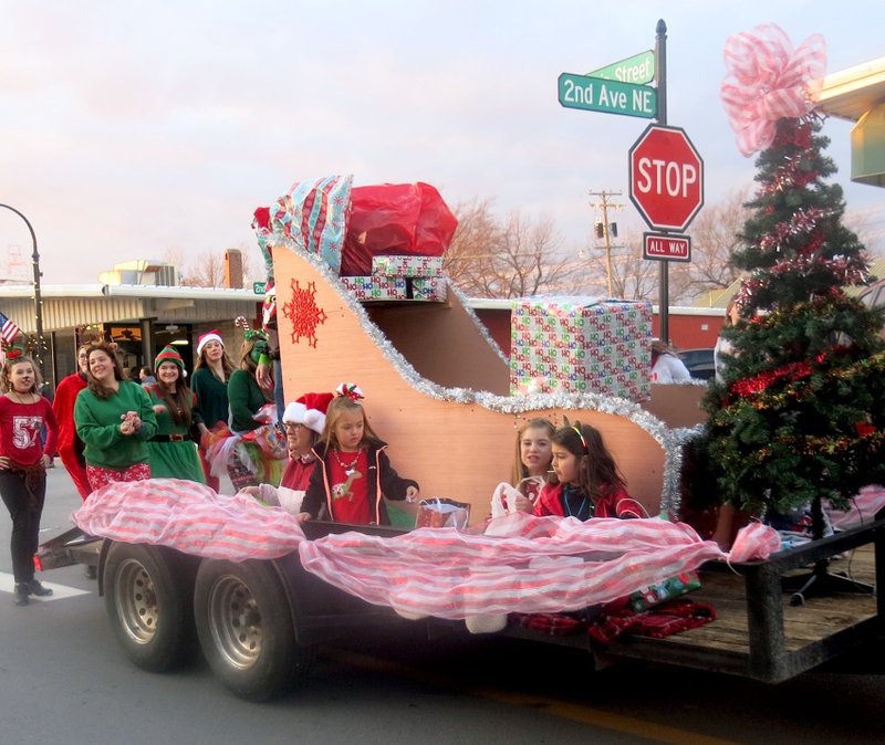 The float from Dynamic Rhythm Dance Studio, with its gaily decorated tree and a sleigh carrying gifts, attracted much attention in the Gravette Christmas parade. The float received the trophy for most festive entry in the parade and was followed by a group of tap dancers who showed off some of their dance steps.