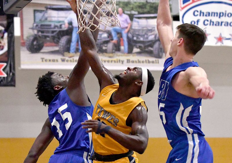 Photo courtesy of Texas Wesleyan
John Brown sophomore Densier Carnes, left, and senior Josh Bowling defend Saturday against Texas Wesleyan. The Golden Eagles defeated the No. 11-ranked Rams to complete a two-game road trip in Texas. JBU also won at Southwestern Assemblies of God last Thursday.