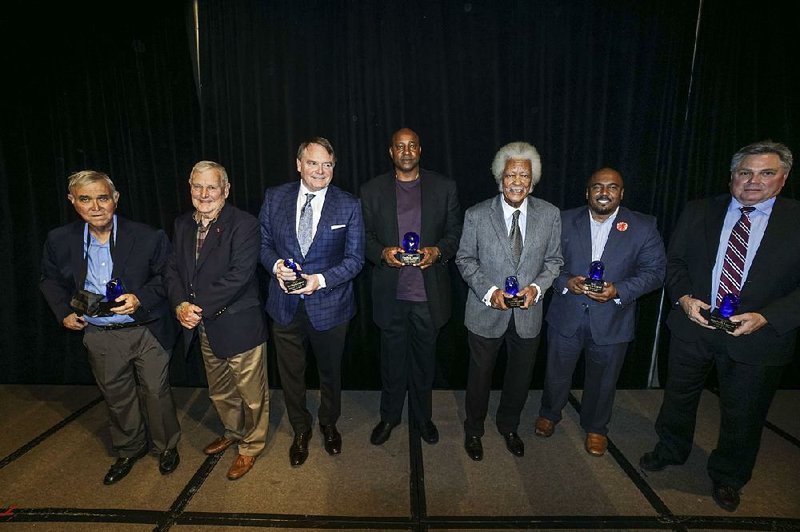 The inaugural class of the OneRock Legends Hall of Fame was inducted Wednesday in Little Rock. Pictured are (from left) Charles Ripley, keynote speaker Harold Horton, Houston Nutt, Sidney Moncrief, Oliver Elders, Darrell Brown (accepting for DeeDee Brown-Campbell) and Bruce Matthews (accepting for Wilson Matthews). 