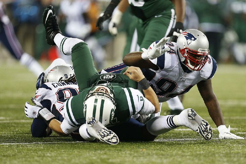 Mark Sanchez (center) knows that, fairly or not, his name will always be associated with “The Butt Fumble.” 