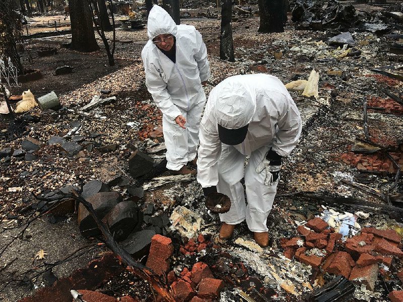 Jerry and Joyce McLean search for keepsakes among the ashes of their home Wednesday in Paradise, Calif. 