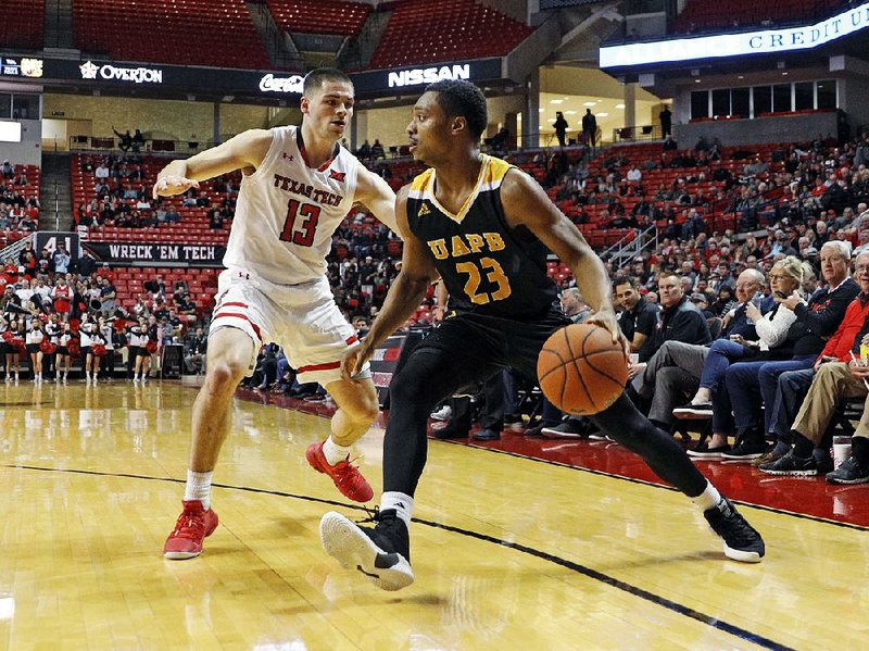 Martaveous McKnight (right) scored 27 points Wednesday night, but he was the only UAPB player with more than four in a 65-47 loss to No. 13 Texas Tech in Lubbock, Texas.