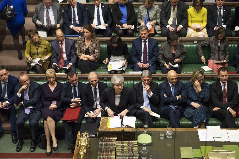 Britain’s Prime Minister Theresa May (center) addresses lawmakers’ concerns about her European Union deal Wednesday in the House of Commons in London. 