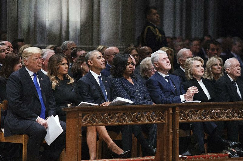 President Donald Trump (from left), his wife, Melania; former President Barack Obama and his wife, Michelle; former President Bill Clinton and Hillary Clinton; and former President Jimmy Carter and his wife, Rosalyn (not pictured) share the front pew Wednesday at the National Cathedral for the funeral of former President George H.W. Bush. 