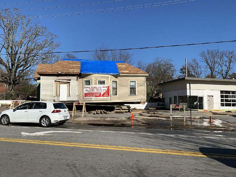 The house behind the former service station at Kavanaugh Boulevard and Beechwood Street is being moved rather than demolished as part of a plan to convert the property into a burger restaurant with green space. 