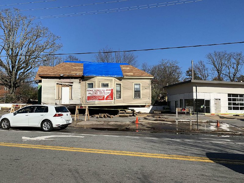 The house behind the former service station at Kavanaugh Boulevard and Beechwood Street is being moved rather than demolished as part of a plan to convert the property into a burger restaurant with green space. story.lead_photo.caption