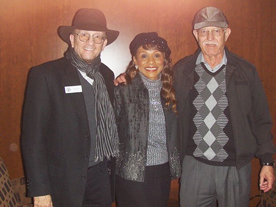 Submitted photo SINGER HONORED: From left are John Rumble, senior historian of the Country Music Hall of Fame and Museum, Petrella and Bob Pollefeyt, Petrella's manager.