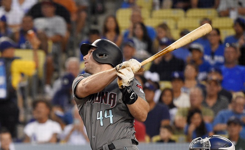 In this Aug. 31, 2018 file photo Arizona Diamondbacks' Paul Goldschmidt hits a two-run home run during the first inning of a baseball game against the Los Angeles Dodgers in Los Angeles.