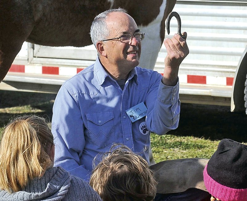 File Photo/NWA Democrat-Gazette/FLIP PUTTHOFF Jim House shows students at Barker Middle School in Bentonville horse shoes in April 2014 during the Horse Tails Literacy Project at the school. House died in a farming accident Wednesday.