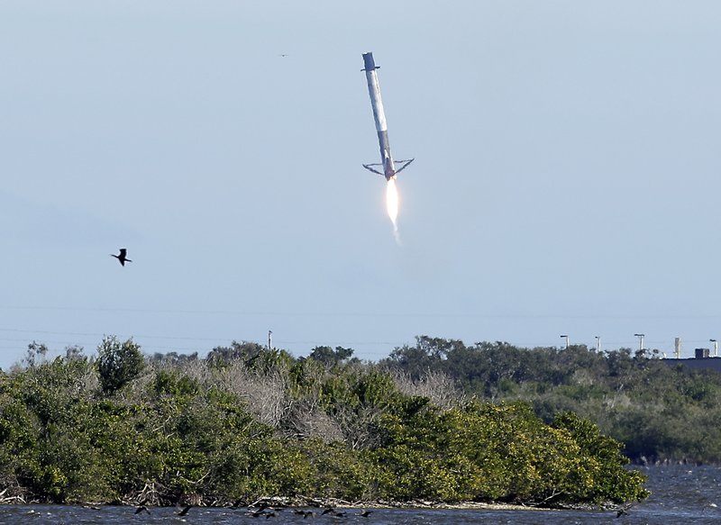 The first stage booster from a Falcon 9 rocket experiences a control problem during its descent, landing in the Atlantic Ocean just east of the launch site instead of a landing zone at the Cape Canaveral Air Force Station in Cape Canaveral, Fla., Wednesday, Dec. 5, 2018. (AP Photo/John Raoux)