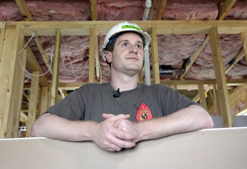 In this Sept. 26 file photo, Democratic congressional candidate Dan McCready leans against wallboard as he pauses during a Habitat For Humanity building event in Charlotte, N.C. The nation's last unresolved fall congressional race with McCready against Republican Mark Harris is awash in doubt as North Carolina election investigators concentrate on a rural county where absentee-ballot fraud allegations are so flagrant they've put the Election Day result into question. (AP Photo/Chuck Burton, File)

