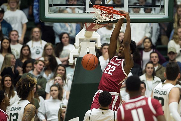 Arkansas forward Gabe Osabuohien (22) dunks on Colorado State during an NCAA college basketball game, Wednesday, Dec. 5, 2018, in Fort Collins, Colo. (Timothy Hurst/The Coloradoan via AP)

